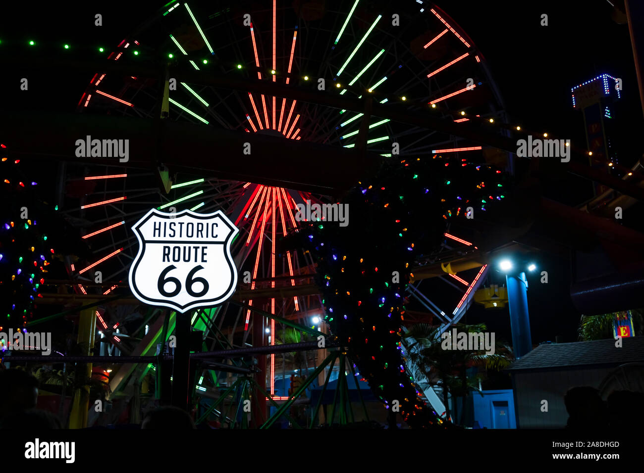 Neon lights on the amusements park and end of route 66 sign. Santa