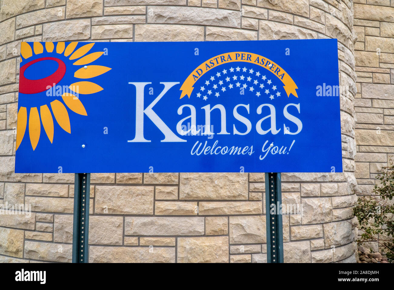 Kansas welcomes you - welcome roadside sign at freeway rest area with a popular Latin phrase ad astra per aspera (through hardships to the stars), dri Stock Photo