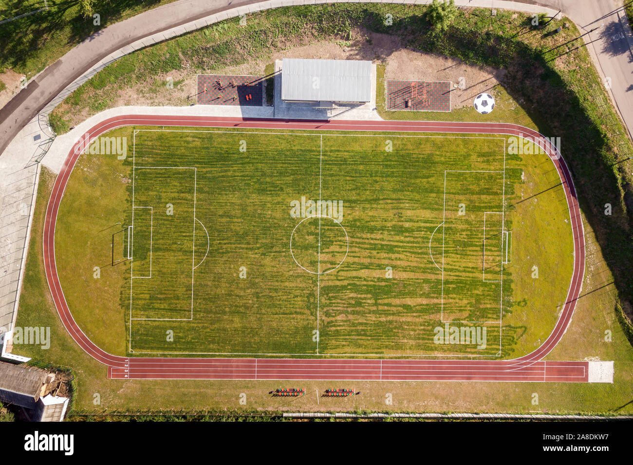 Aerial view of a football field on a stadium covered with green grass
