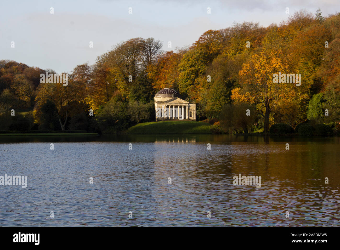 Stourhead stone pavilion. A wonderful folly in the Georgian landscaped gardens of Stourhead. The lake in front and the woods behind. Autumn and sunny Stock Photo
