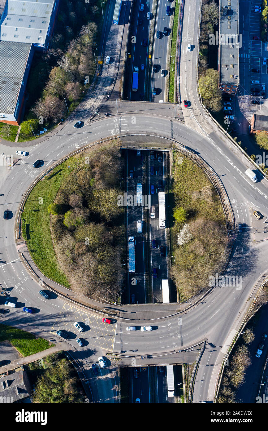 Overhead, aerial views of a roundabout at rush hour, busy with traffic