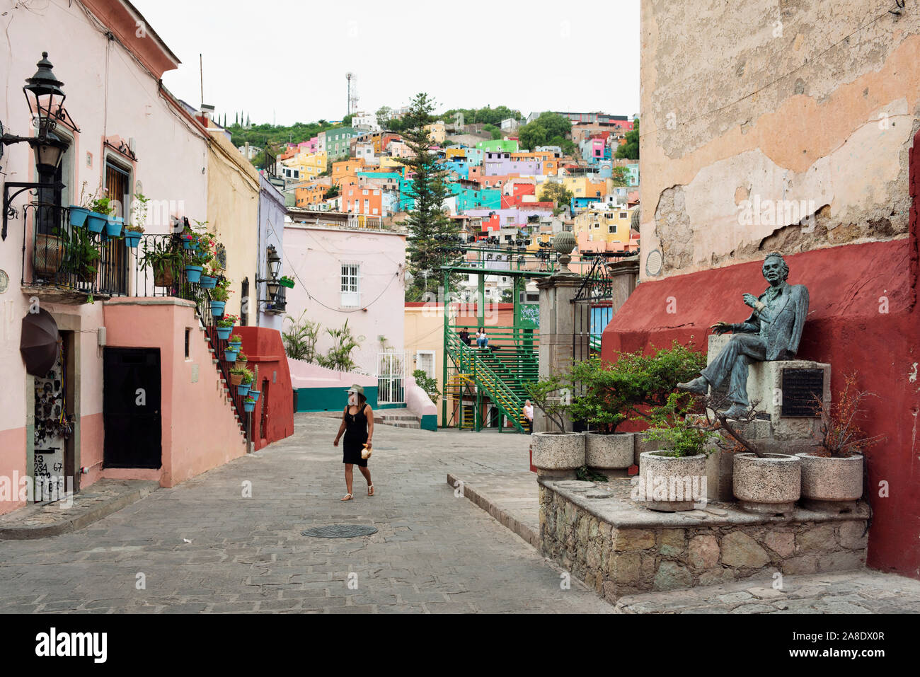Beautiful street view of Roque Street with sculpture of Enrique Ruelas Espinosa. The historic centre of Guanajuato city, Mexico. Jun 2019 Stock Photo