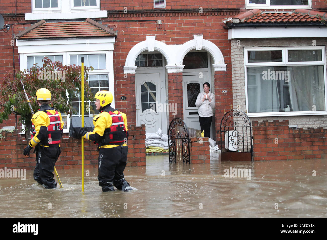 Fire and Rescue service members walk through flood water to rescue residents in Doncaster, Yorkshire, as parts of England endured a month's worth of rain in 24 hours, with scores of people rescued or forced to evacuate their homes, others stranded overnight in a shopping centre, and travel plans thrown into chaos. Stock Photo
