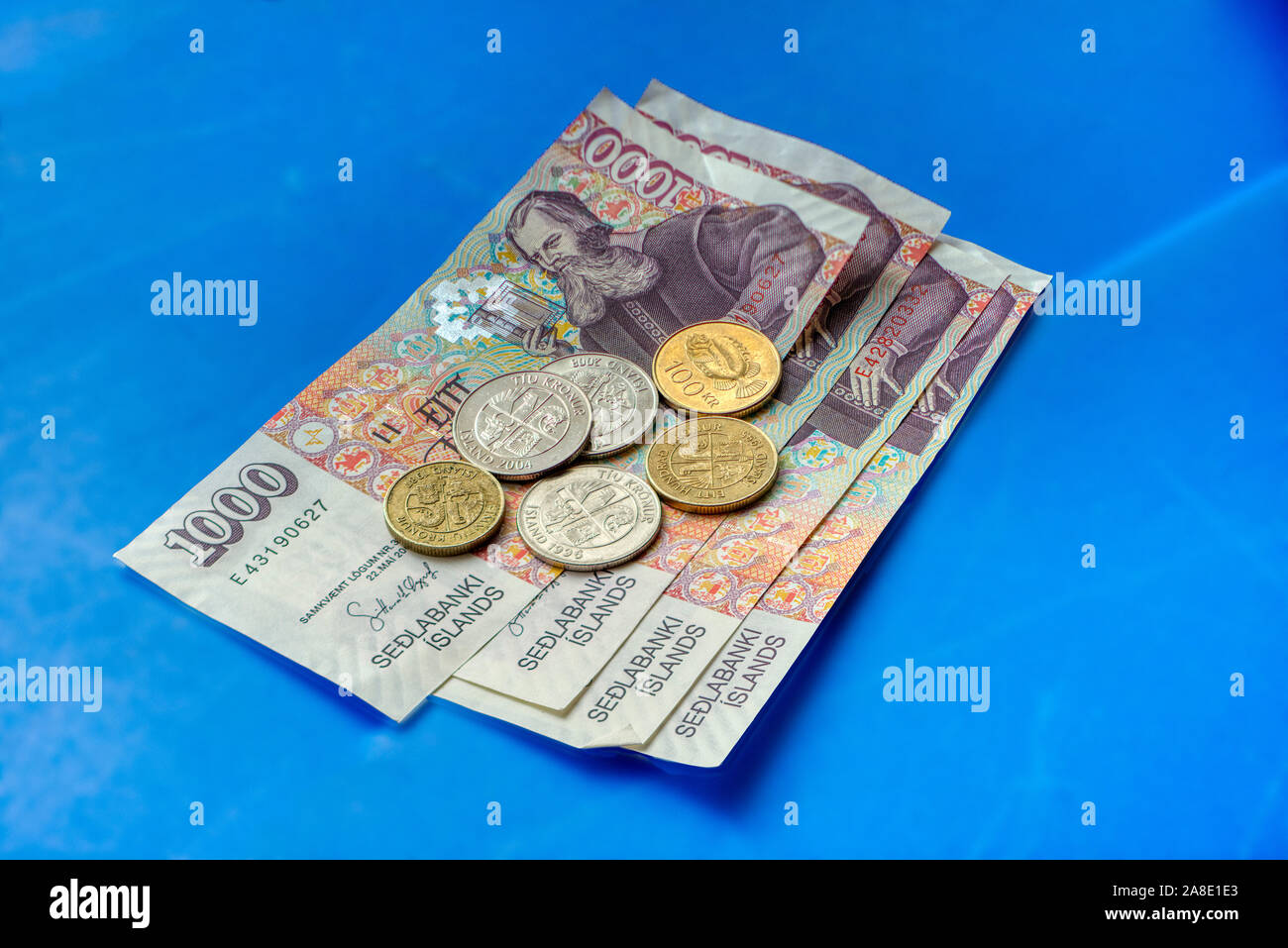 Icelandic currency on a blue background Stock Photo