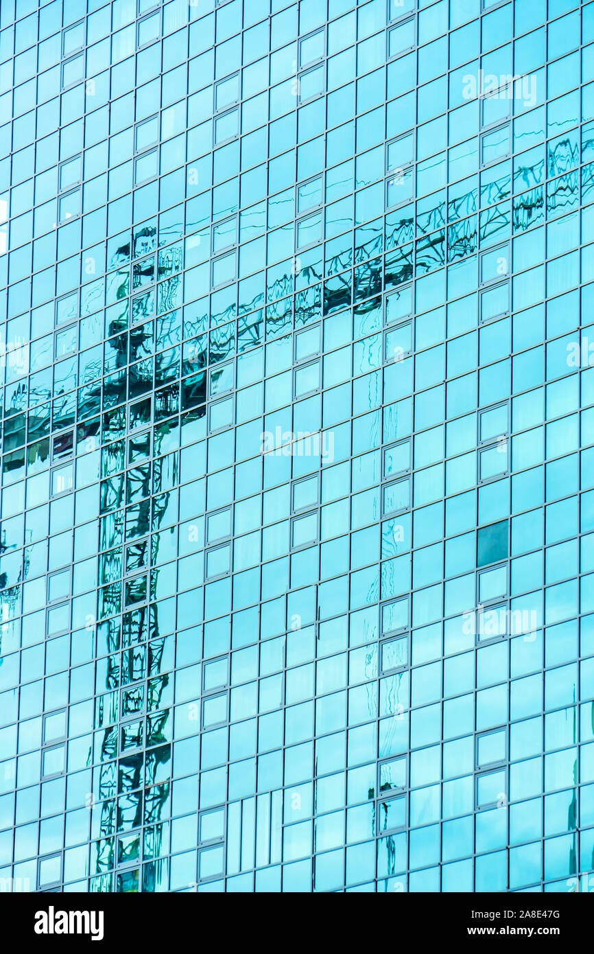 Reflection of tower cranes building construction on building mirror ...