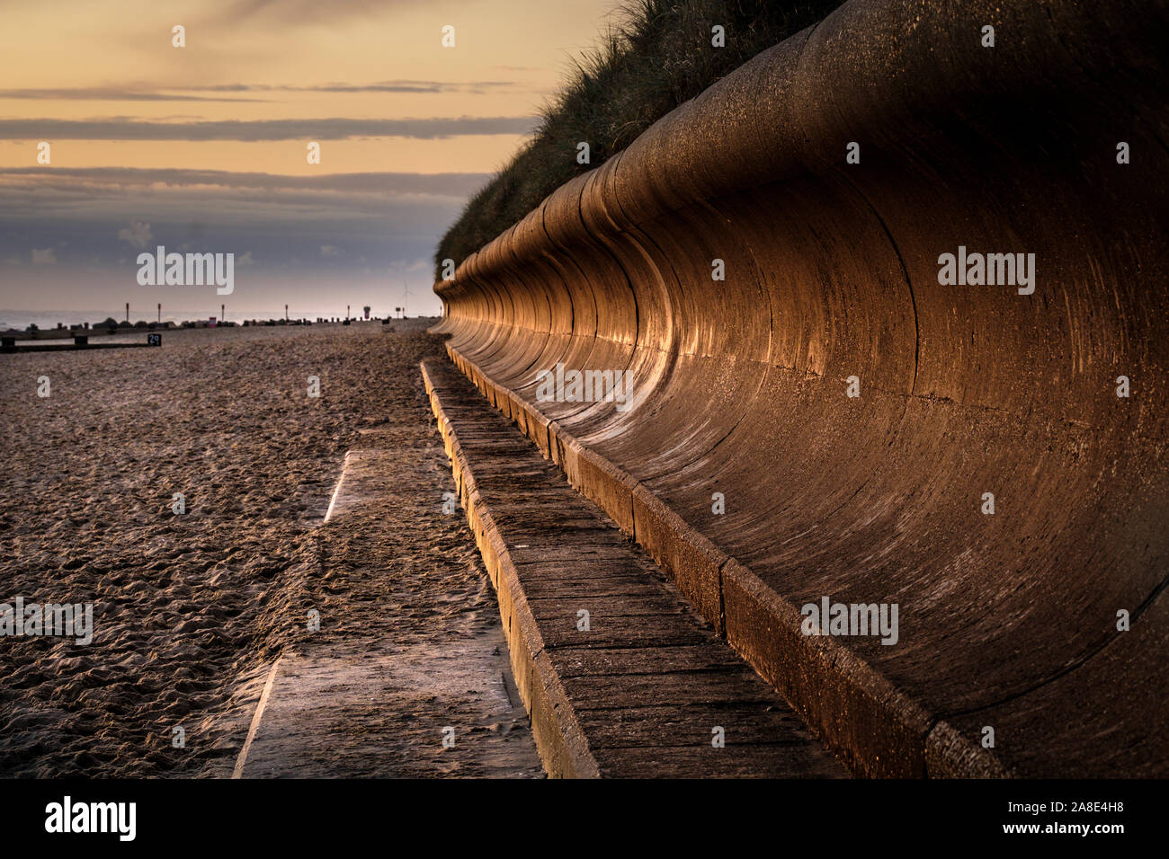 Concave concrete seawall on the Norfolk coast. Stock Photo