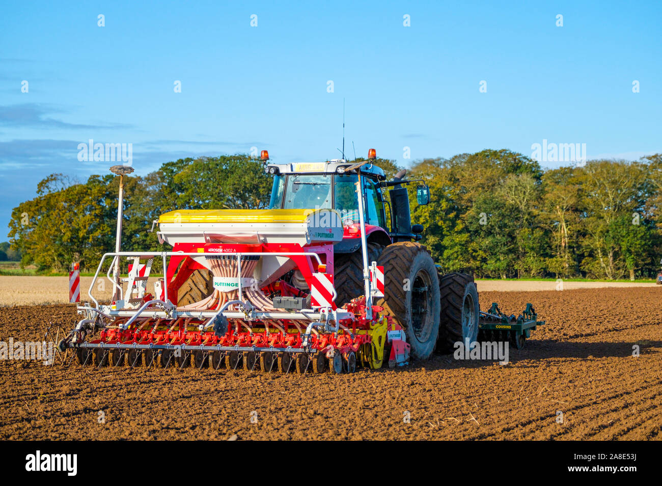 A tractor with a Pottinger Aerosem 4002 pneumatic seed drill. Stock Photo