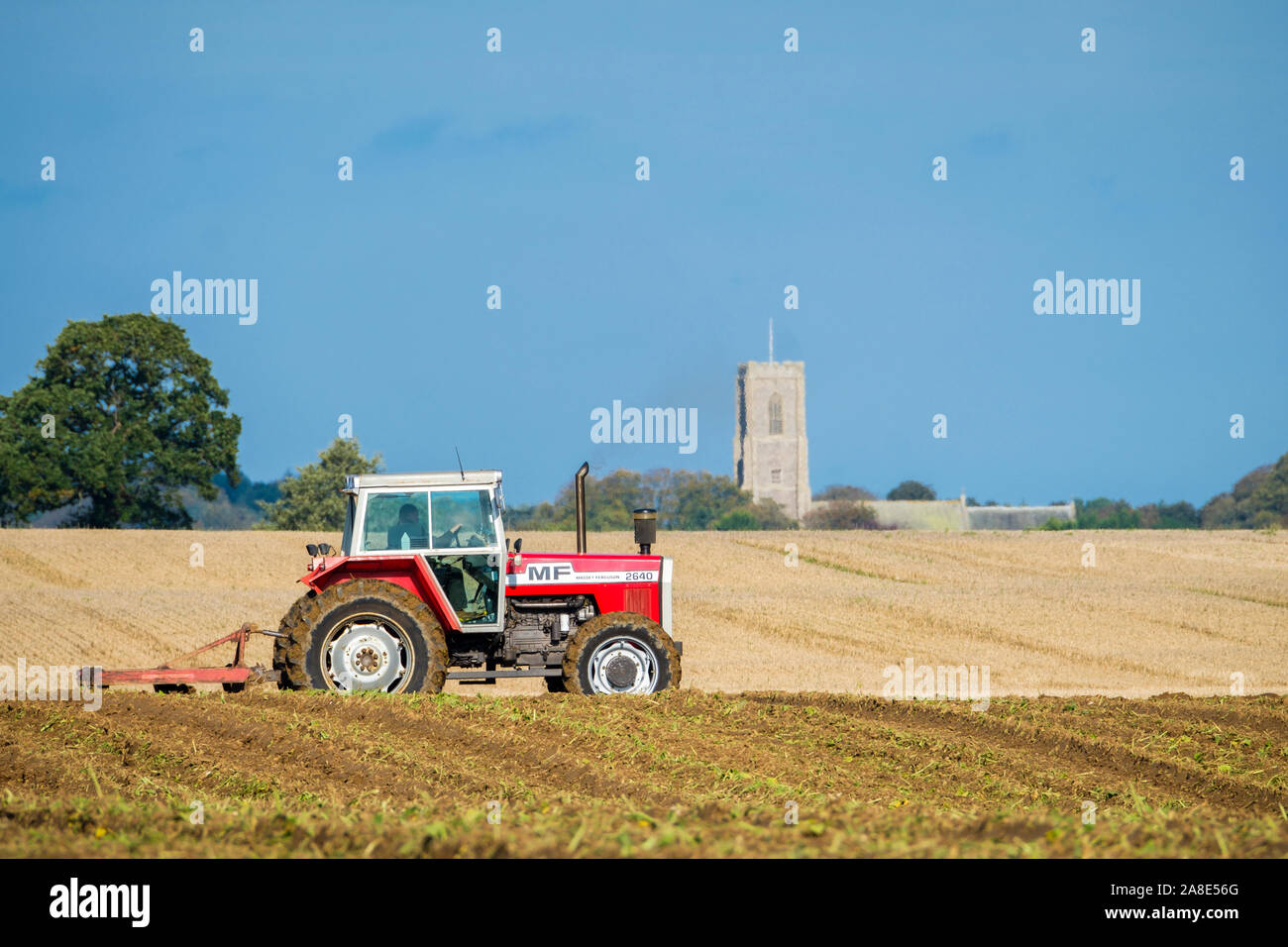 Tractor ploughing land in a typical English scene. Stock Photo