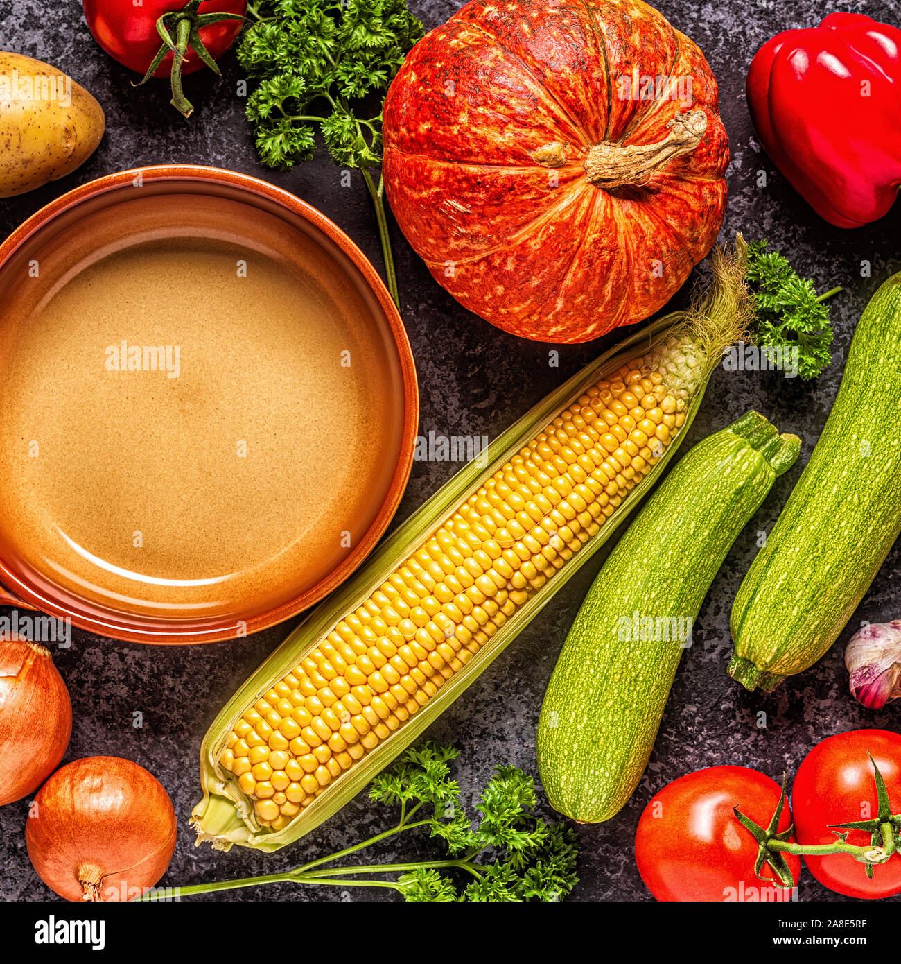 Fresh autumn vegetables for cooking on a dark background, top view. Stock Photo