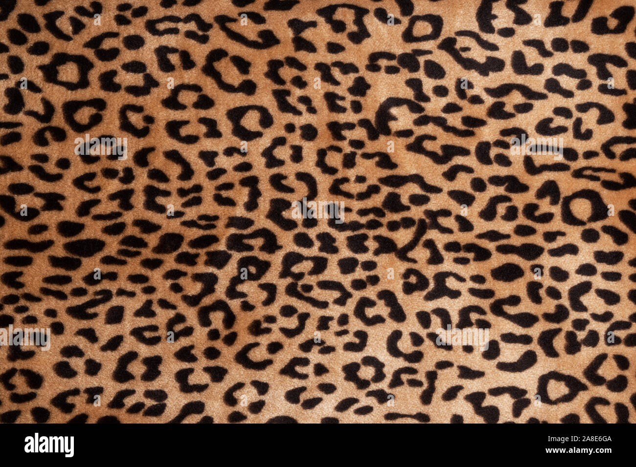 Faux fur leopard texture background. Fashionable modern ecological material. Plaid or carpet. Stock Photo