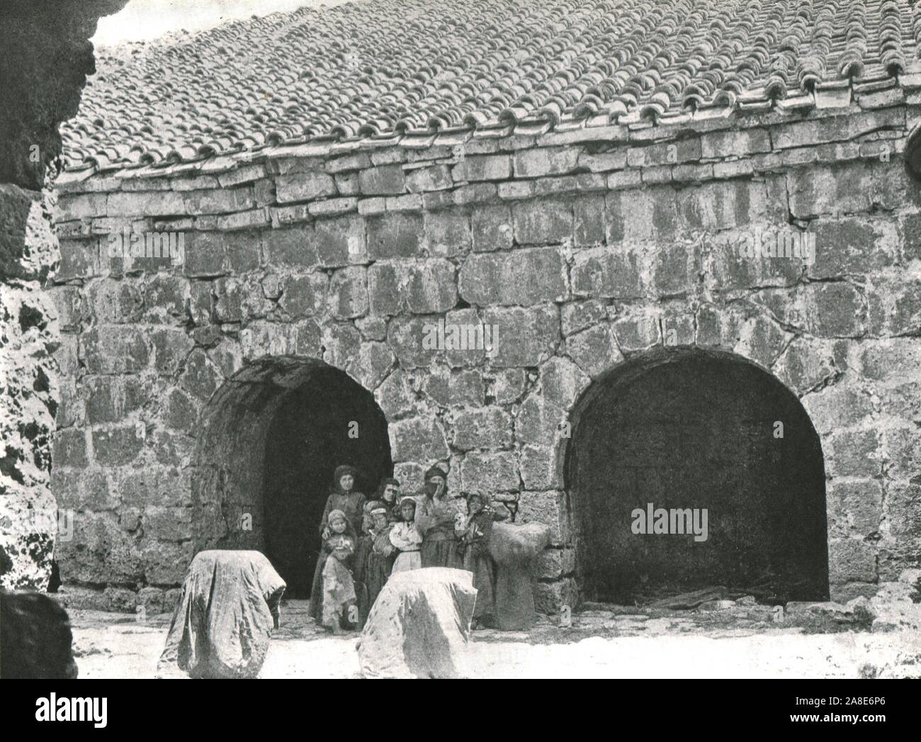 'Deir Amar', c1906-1913, (1915). Women and children outside traditional stone houses in the village of Deir al-Qamar, (Lebanon). From &quot;The Caliphs' Last Heritage, a short history of the Turkish Empire&quot; by Lt.-Col. Sir Mark Sykes. [Macmillan &amp; Co, London, 1915] Stock Photo