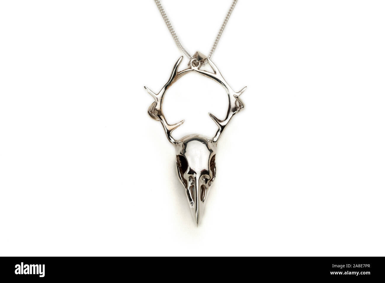 Silver crow skull and stag antlers necklace pendant. Stock Photo