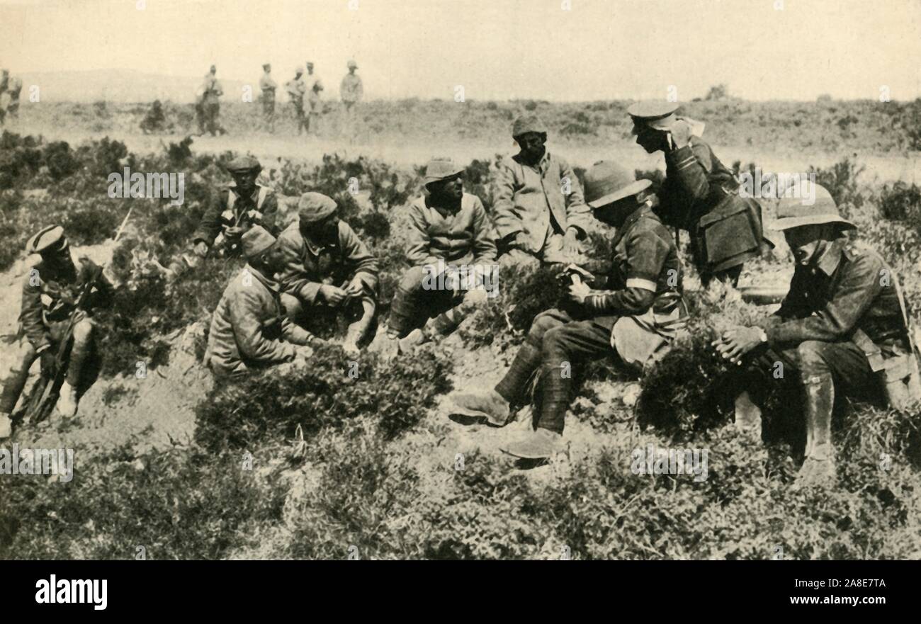 'Prisoners of War: interrogating captured Turks', First World War, c1917-1918, (c1920). British soldiers with Turkish prisoners on the Eastern Front. From &quot;The Great World War: A History&quot;, Volume VII, edited by Frank A Mumby. [The Gresham Publishing Company Ltd, London, c1920] Stock Photo
