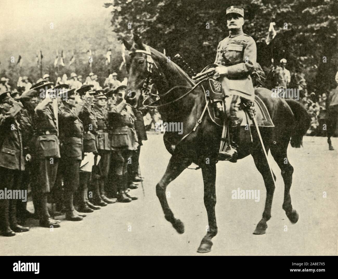 Marshal Foch at the Victory Day Procession, London, 19 July 1919, (c1920). 'A Salute from the Guards: Marshal Foch, baton in hand, riding at the head of the French troops...'. Marshal Ferdinand Foch (1851-1929), supreme commander of the Allied Armies, takes part in the Peace Day celebrations to mark the end of the First World War. From &quot;The Great World War: A History&quot;, Volume IX, edited by Frank A Mumby. [The Gresham Publishing Company Ltd, London, c1920] Stock Photo