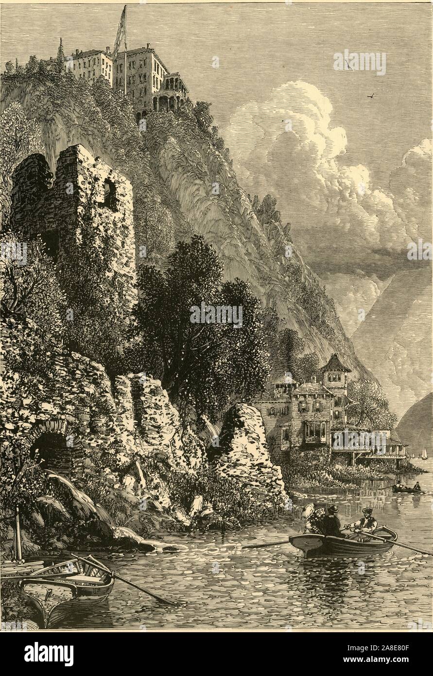 'The Hudson at &quot;Cozzens's&quot;', 1874. Cozzen's Hotel at West Point on the River Hudson, New York State, USA: 'Cozzens's, that familiar and great resort of summer pleasure-seekers, perched high on the brow of the cliff that is the most prominent on the western shore for several miles below the Military Academy. Nothing could be more picturesque than the situation of the great building of the hotel, high up in air, looking down upon all the noblest of the river-views. It is several hundred feet above the water...the precipice is here so bold and rugged that the most practised eye is decei Stock Photo