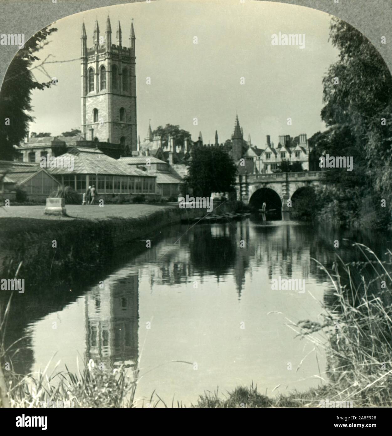 'Looking Northeast from the River Cherwell to the Tower of Magdalen College, Oxford, England', c1930s. The college choir sings from the top of Magdalen Tower on May Morning. From &quot;Tour of the World&quot;. [Keystone View Company, Meadville, Pa., New York, Chicago, London] Stock Photo