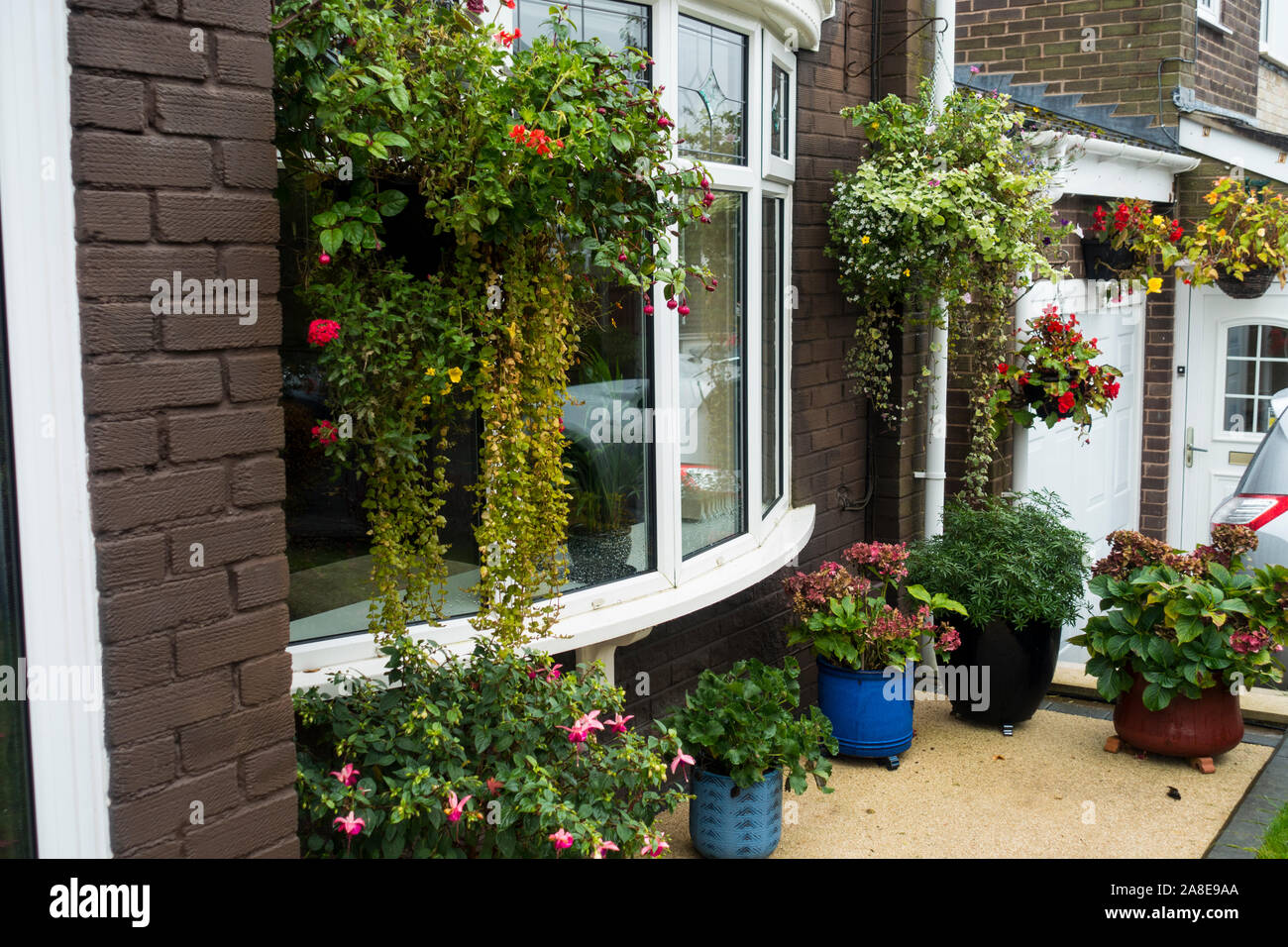 Pots and Hanging Baskets on a front Patio in autumn, England, UK Stock