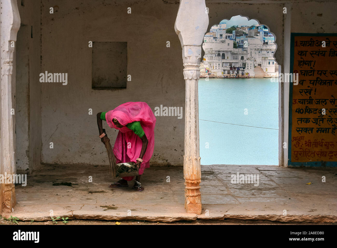 Pushkar, Rajasthan, India: an Indian woman cleaning the sidewalk Stock Photo