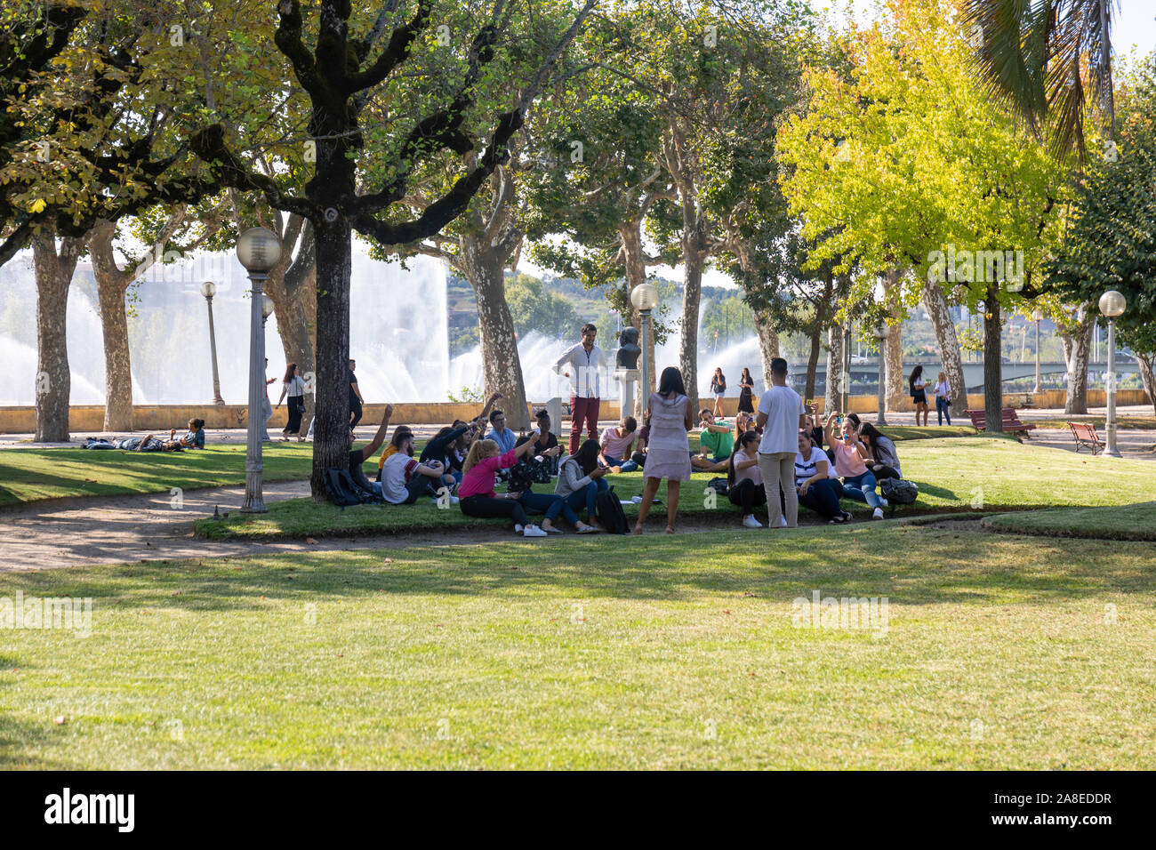 The University Town of Coimbra, Portugal.  Students enjoy a lecture in the park in the shade of the trees Stock Photo