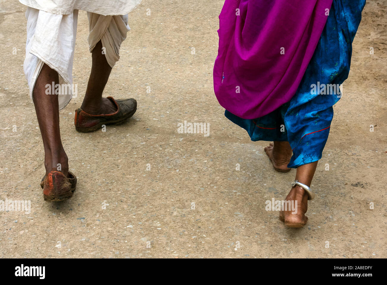 Pushkar, Rajasthan, India: The legs of a walking Indian couple . Stock Photo