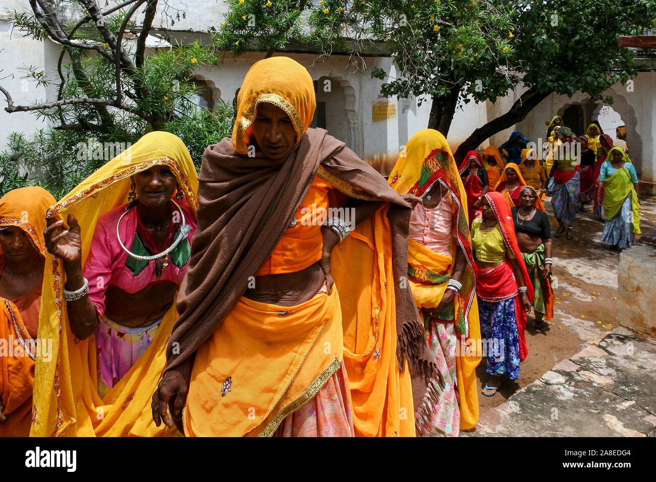 Pushkar, Rajasthan, India: Group of Indian women crossing a courtyard during a pilgrimage to Pushkar Stock Photo