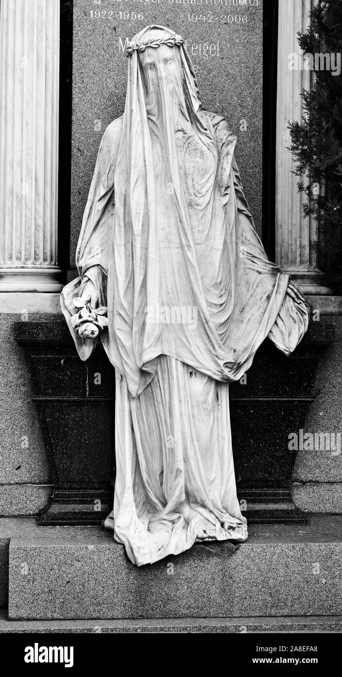 Iconic statue in the Central Cemetery of Vienna, Austria, monochrome. Stock Photo