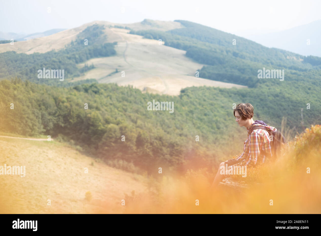 Boy with backpack in beauty autumn mountains . Travel concept. Landscape photography Stock Photo