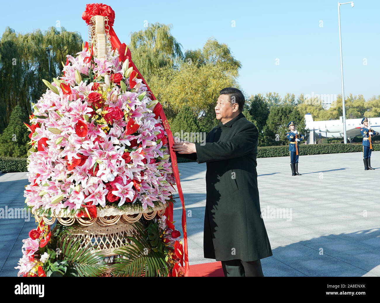 (191108) -- BEIJING, Nov. 8, 2019 (Xinhua) -- Chinese President Xi Jinping, also general secretary of the Communist Party of China (CPC) Central Committee and chairman of the Central Military Commission (CMC), presents a flower basket to the deceased heroes of the People's Liberation Army (PLA) Air Force at the China Aviation Museum in Changping District, Beijing, capital of China, Nov. 8, 2019. Xi on Friday attended an event celebrating the 70th founding anniversary of the PLA Air Force in the northern outskirts of Beijing. On behalf of the CPC Central Committee and the CMC, he extended congr Stock Photo