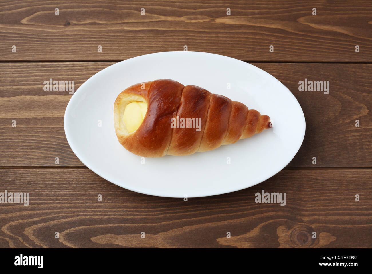Cream Cornet Roll Bread On Plate Isolated On Table Stock Photo Alamy