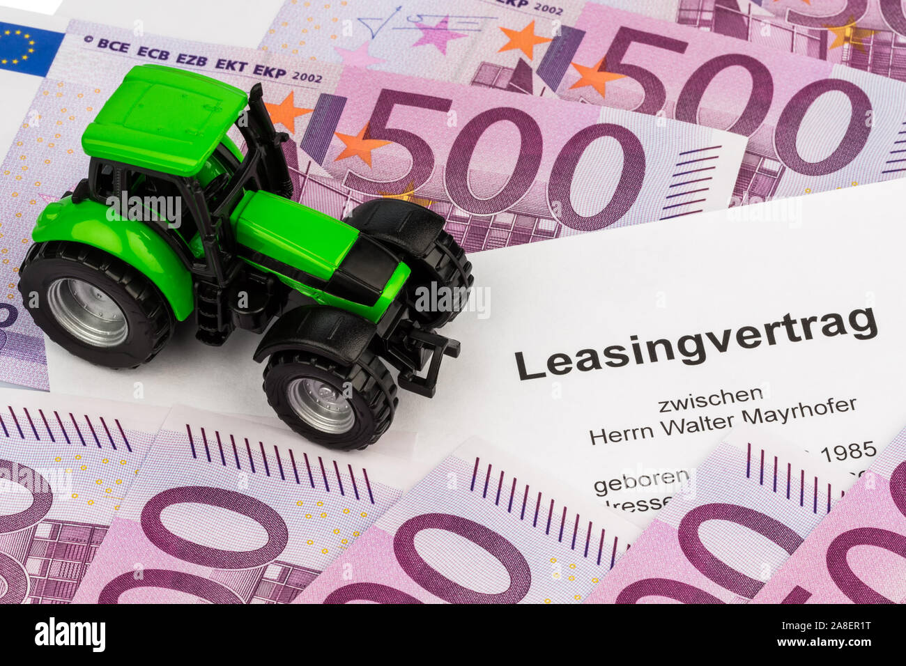 Der Leasingvertrag fuer einen neuen Traktor. Mit Eurogeld und Kugelschreiber Stock Photo