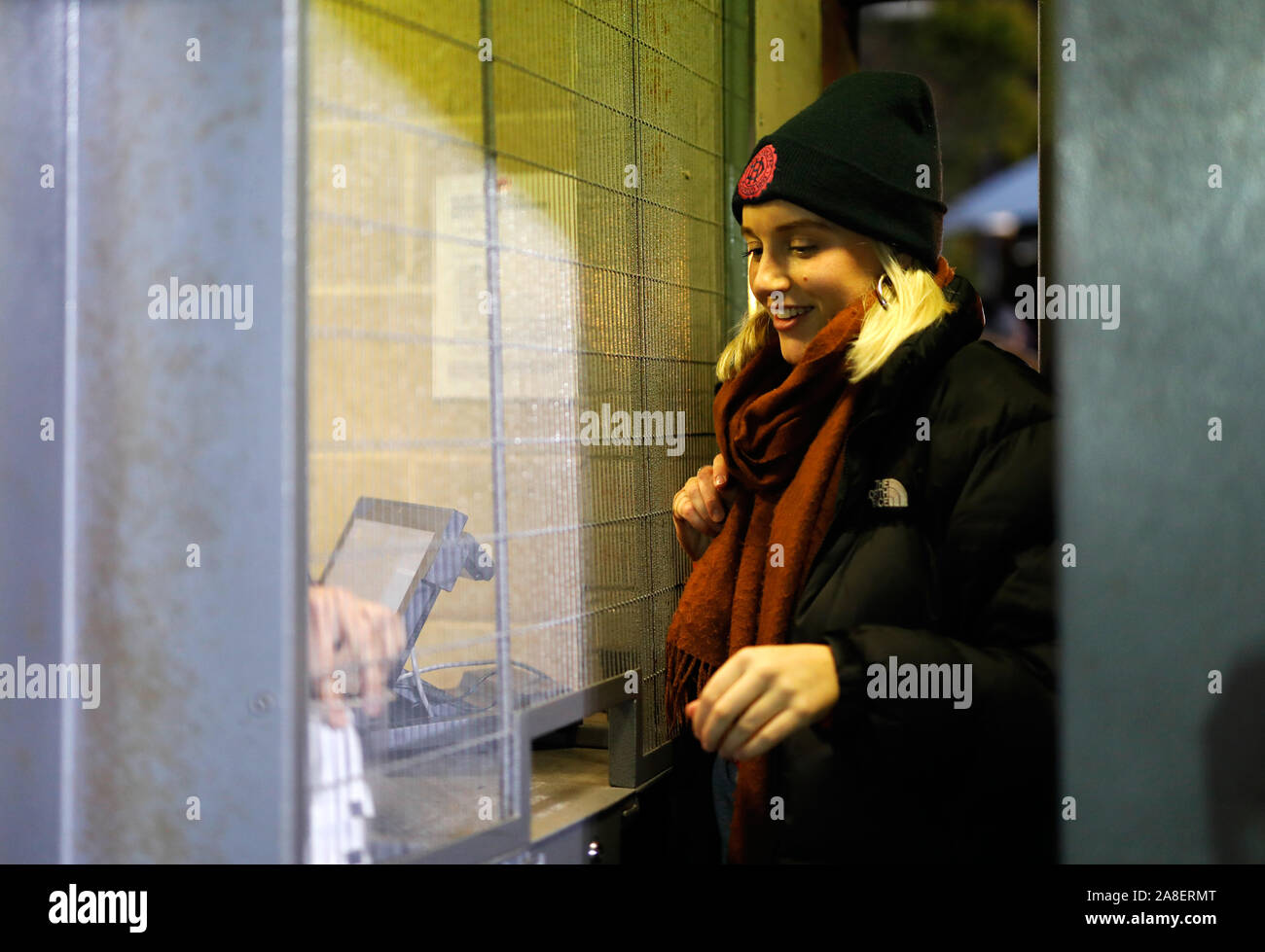A fan enters the stadium through a turnstile before the FA Cup First Round match at Champion Hill, London. Stock Photo