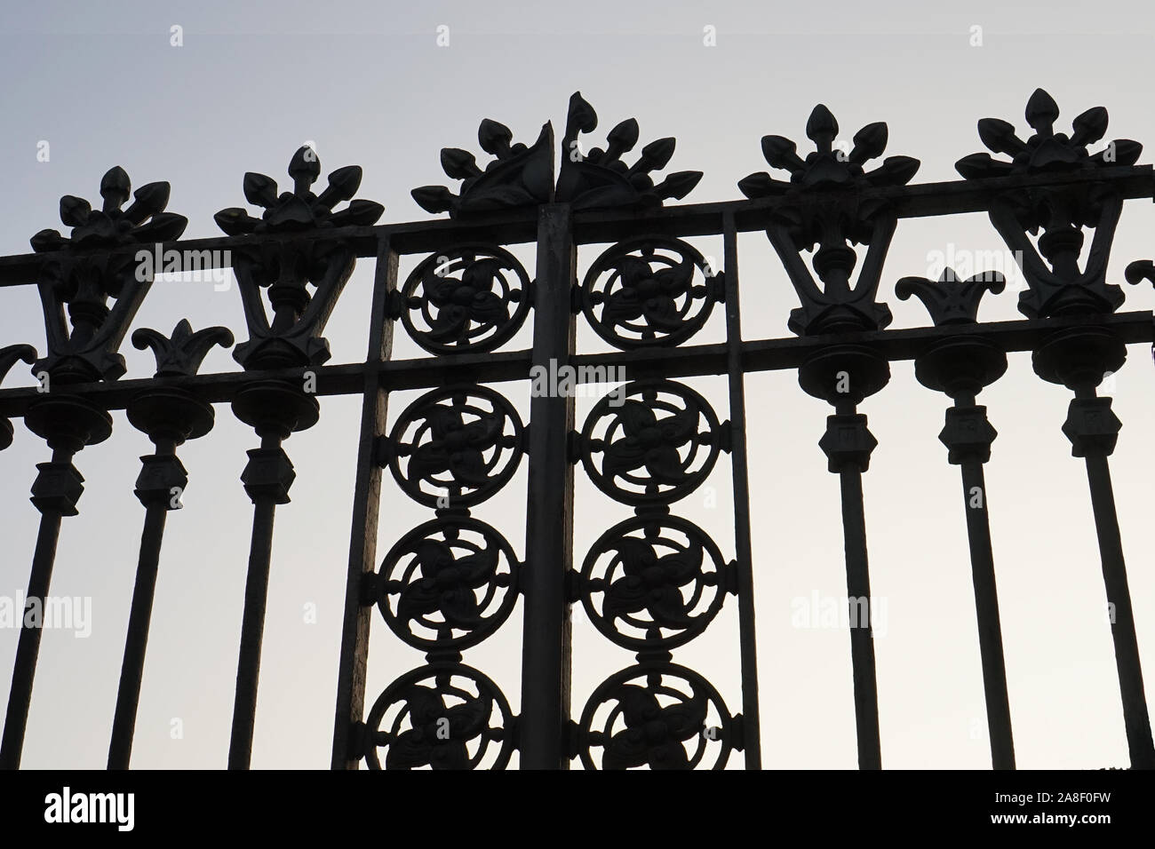A silhouette image of a cast iron ornate gate Stock Photo