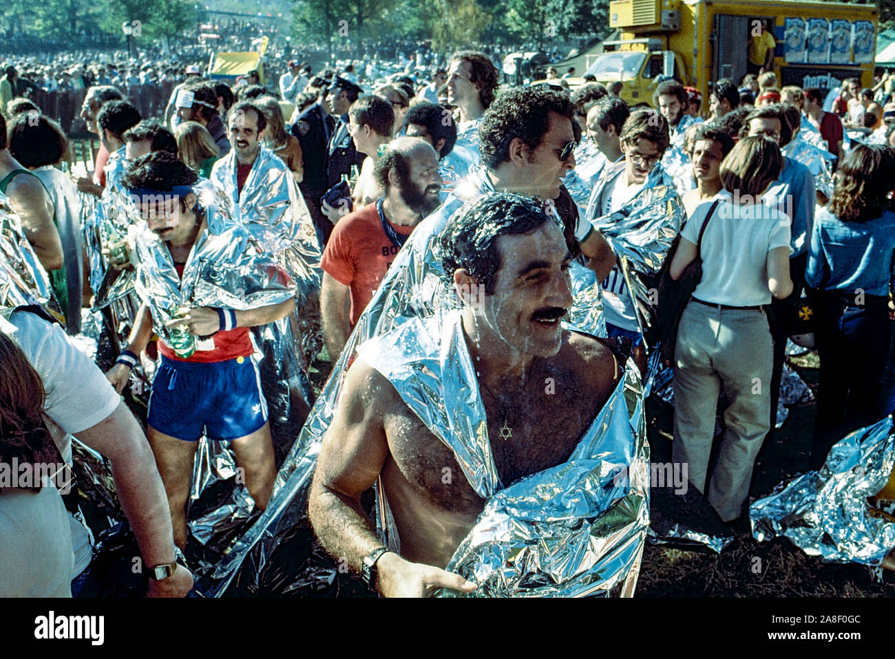 Runners in post race in Central Park wearing space blankets after