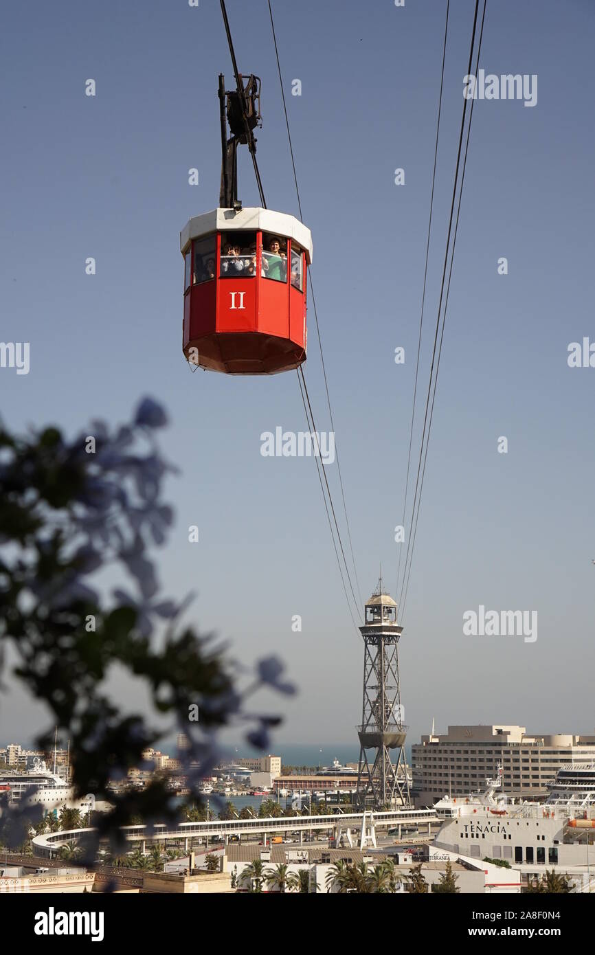 cable car riding up to the top taking in the views of Barcelona city Stock Photo