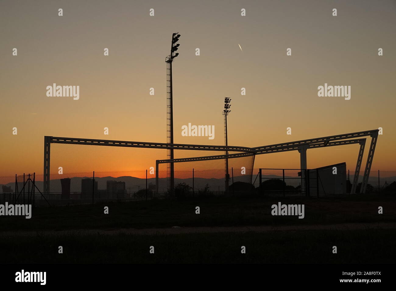 The edge of Barcelona city sports park with silhouettes in the sunset Stock Photo