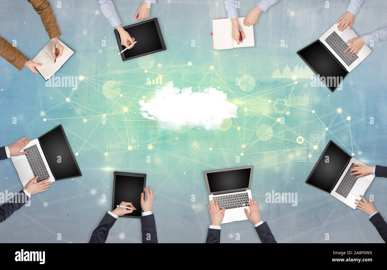 Group of people with devices in hands working on reports with online ...
