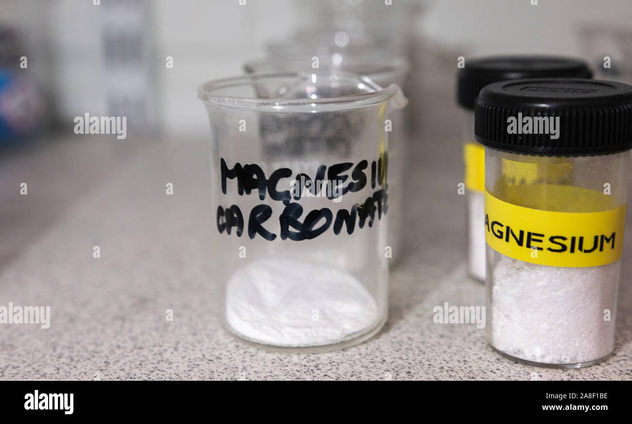 Magnesium carbonate powder in a glass beaker in a chemical store in the
