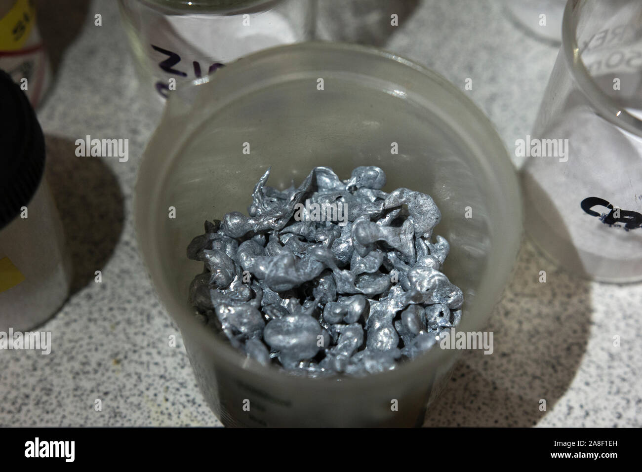 zinc granules in a plastic tub in a chemical store in the UK Stock Photo