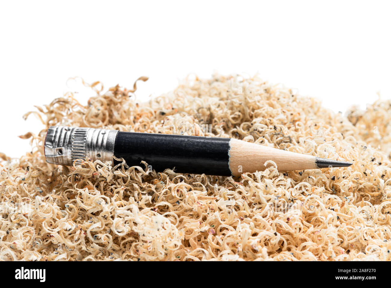 Oversharpened  pencil in front of the heap of shavings. Concept of the fruitless design or art work Stock Photo