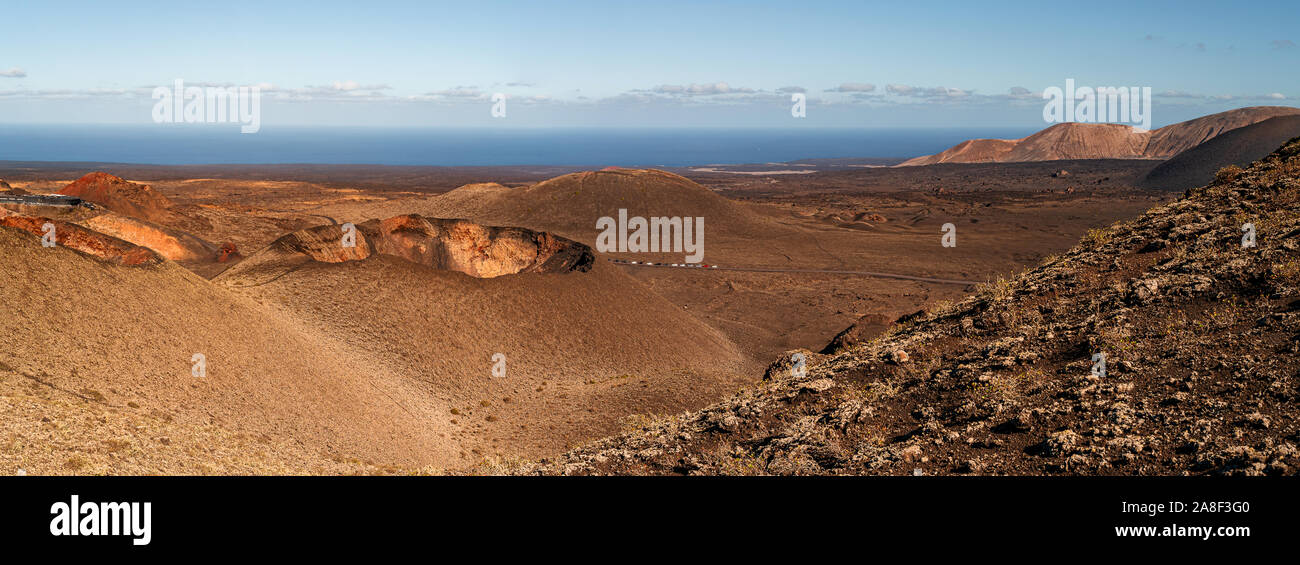 panoramic view of colorful volcanic landscape at Timanfaya National Park on Lanzarote, Canary Islands against clear blue sky Stock Photo