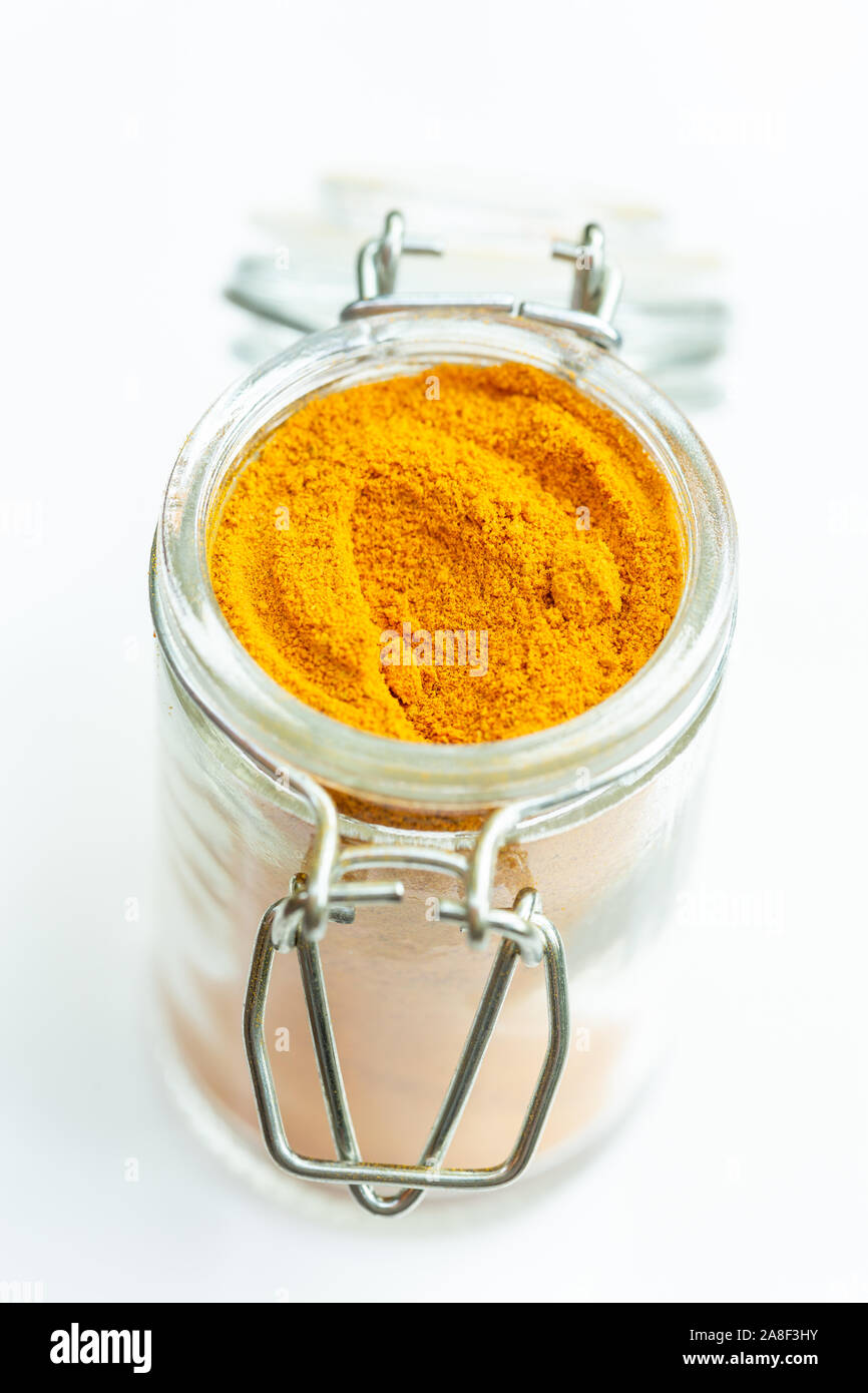 turmeric powder in a glass jar Stock Photo