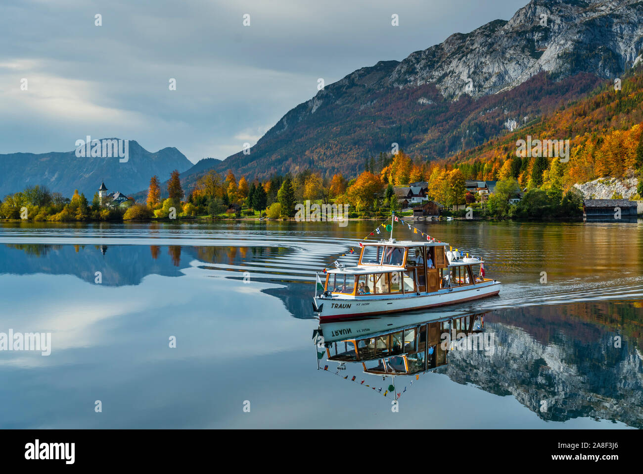 Fall foliage color in the trees and the calm lake with reflections at