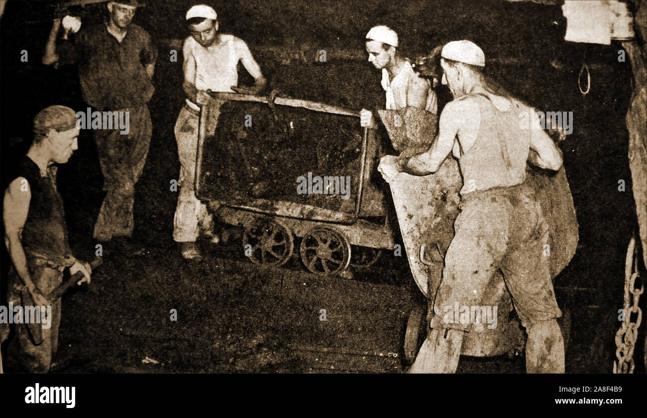 An old photograph showing former tin miners at work in a Cornish tin mine (UK) Stock Photo