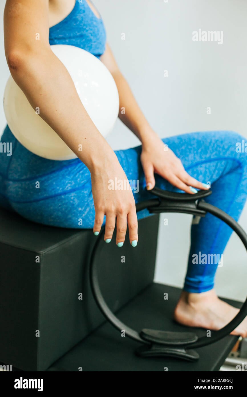 Woman performing Pilates exercise using a Cadillac or Trapeze table Stock Photo