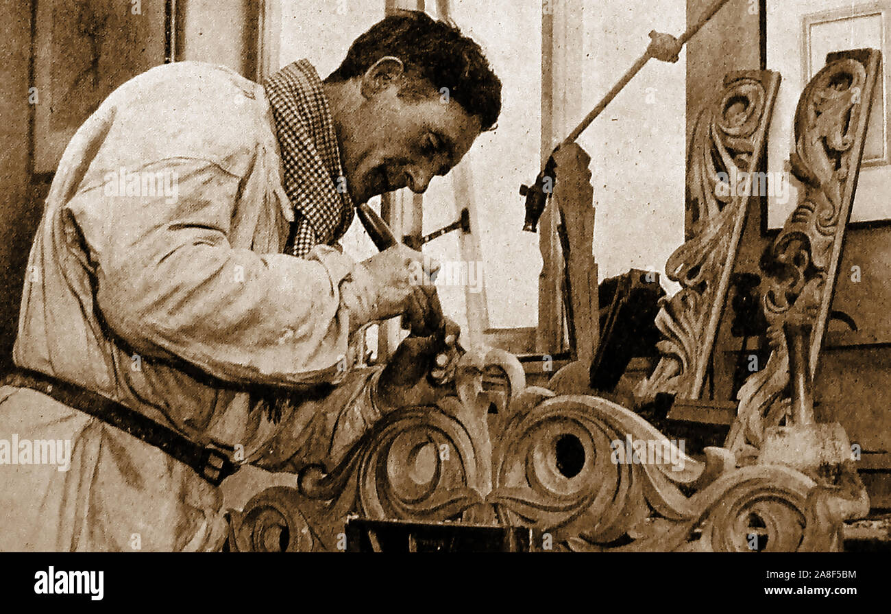 Portrait of British Royal Academy sculptor and artist Sherwood A Edwards  (1897-1960) carving woodwork for a church memorial chapel Stock Photo