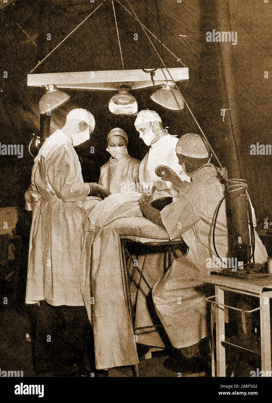 WWII -   Surgeons performing an operation in a 2nd World War  field hospital. Stock Photo
