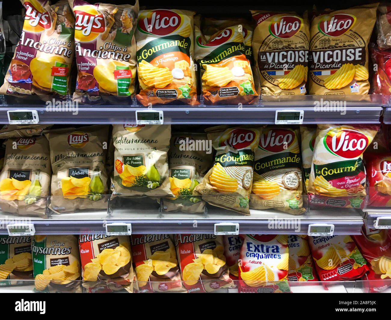 Potatoe chips packed under plastic and aluminium packages displayed on