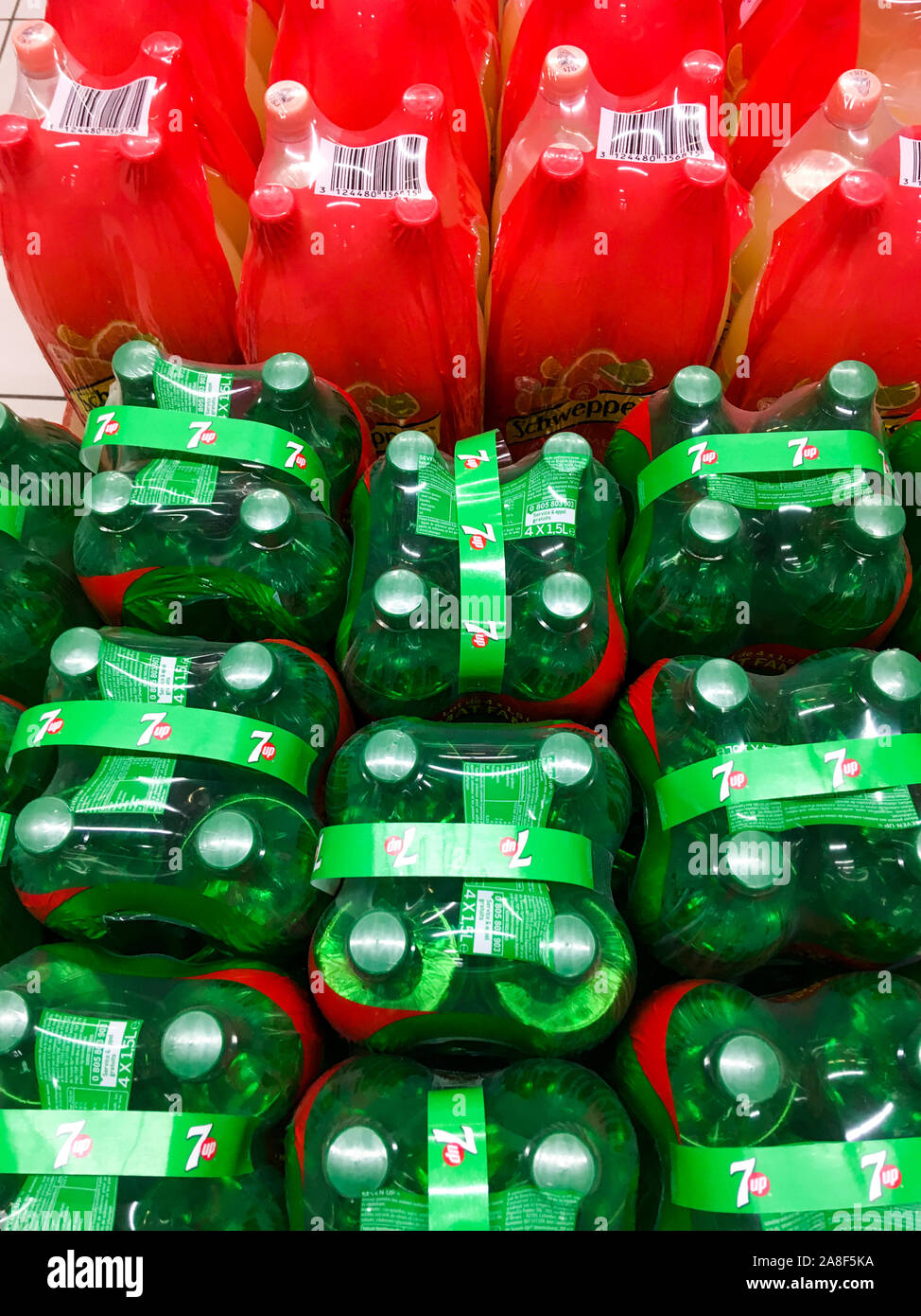 Sodas both conditioned in plastic bottles and packed under plastic film