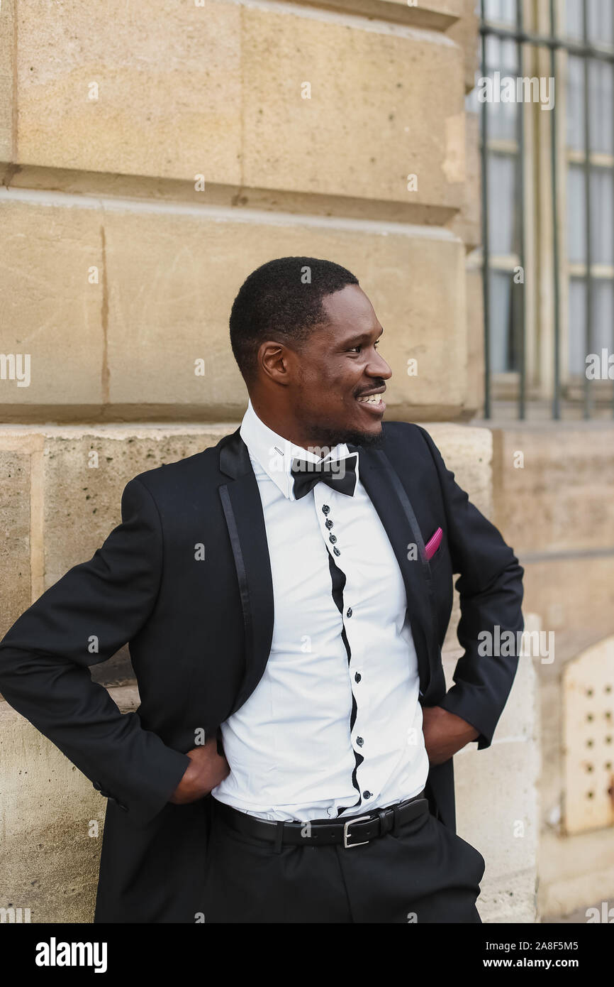 Afro american happy good looking man wearing suit and smiling outdoors ...