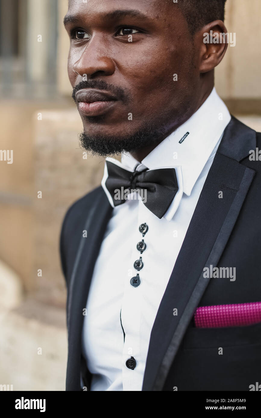 Afro american happy good looking man wearing suit and smiling outdoors ...
